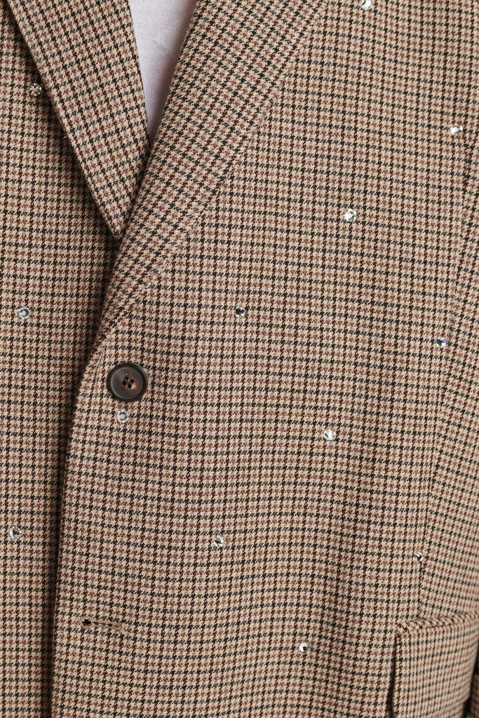 Wide-shouldered blazer in grandpa-inspired check fabric. Spiced-up with sprinkled dazzling Swarovski diamonds, pockets, and exaggerated long sleeves. Fits super oversize.