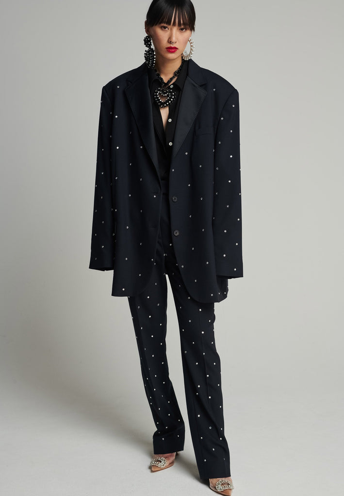 Wide-shouldered blazer in navy. Features sprinkled Swarovski diamonds, shoulder pads, pockets, and exaggerated long sleeves. Fits super oversize.