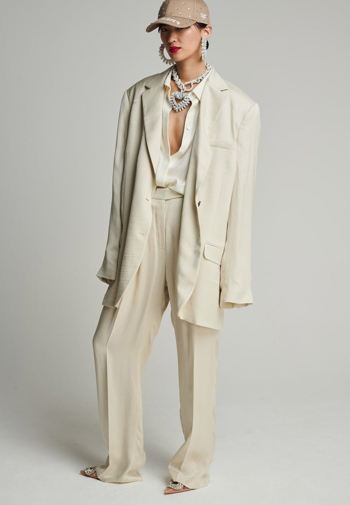 Wide-shouldered striped satin blazer in stone Features shoulder pads, pockets, and exaggerated long sleeves. Fits super oversize.