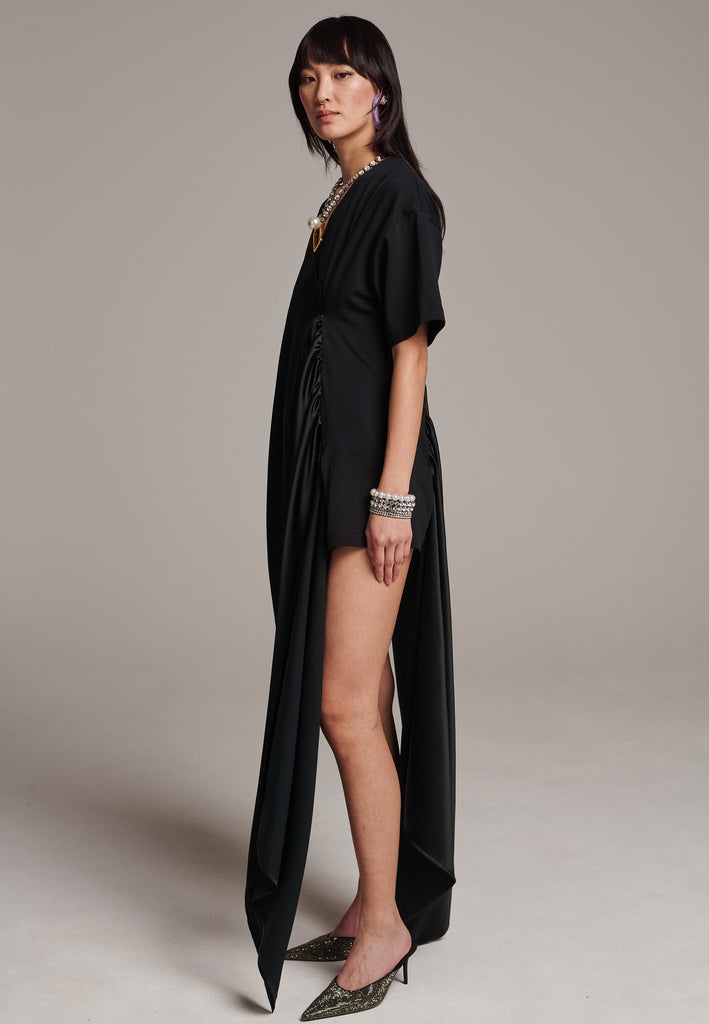 Elevate your wardrobe with this deconstructed dress. Features a v-neckline, dropped shoulders, and an asymmetric detail.