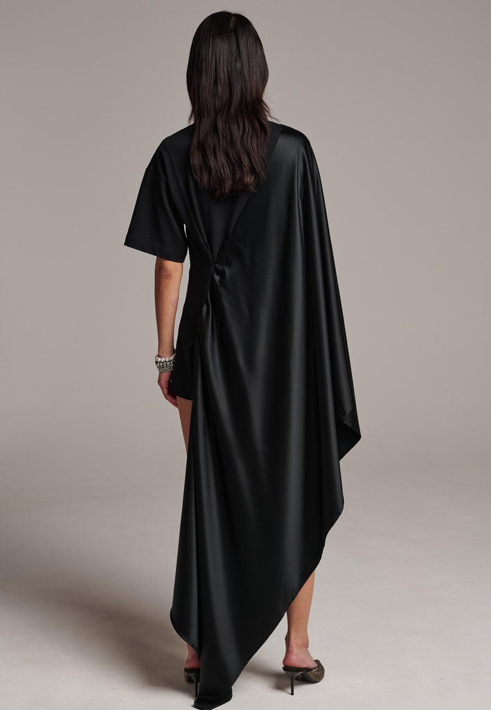 Elevate your wardrobe with this deconstructed dress. Features a v-neckline, dropped shoulders, and an asymmetric detail.