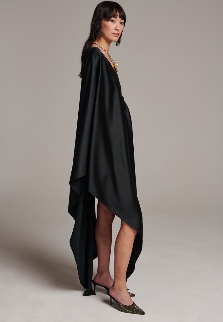 Elevate your wardrobe with this deconstructed dress. Features a v-neckline, dropped shoulders, and an asymmetric detail.