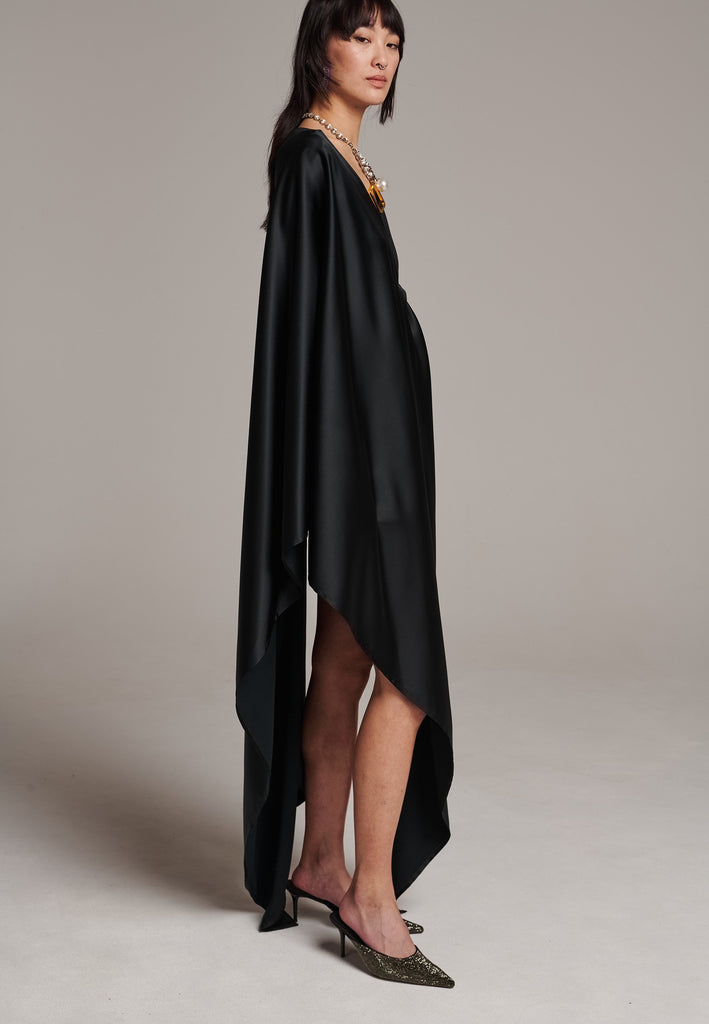 Elevate your wardrobe with this deconstructed dress. Features a v-neckline, dropped shoulders, and an asymmetric detail.