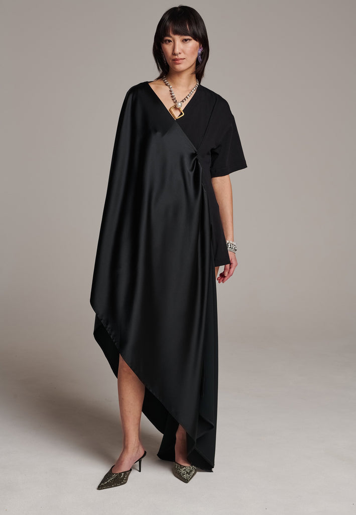 Elevate your wardrobe with this deconstructed dress. Features a v-neckline, dropped shoulders, and an asymmetric detail.