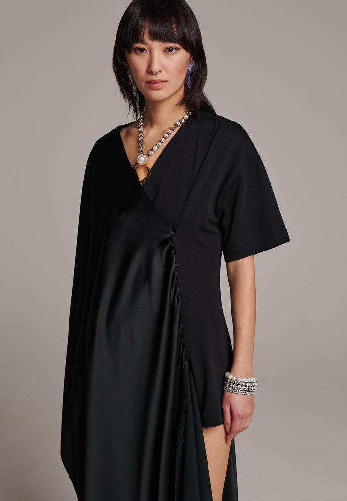 Elevate your wardrobe with this deconstructed dress. Features a v-neckline, dropped shoulders, and an asymmetric detail.