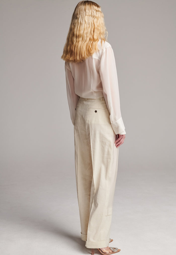 Long wide-leg trousers cut from a linen blend. Detailed with insideout details, welt pockets and button closure.