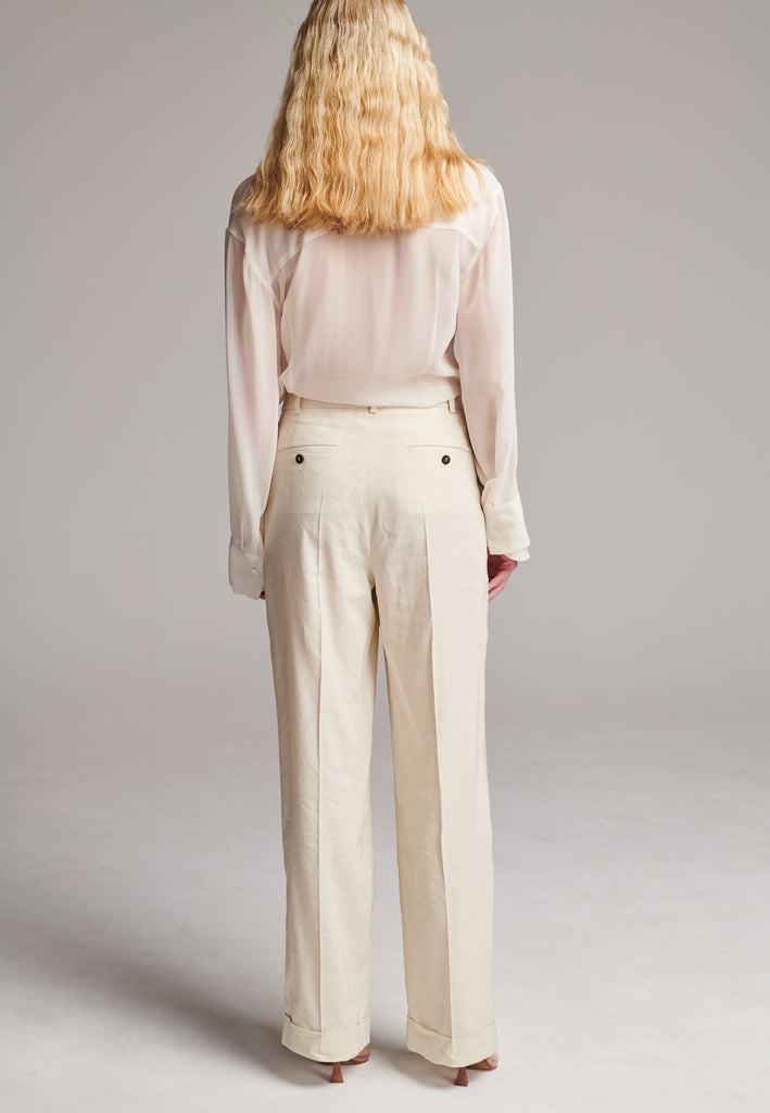 Long wide-leg trousers cut from a linen blend. Detailed with insideout details, welt pockets and button closure.