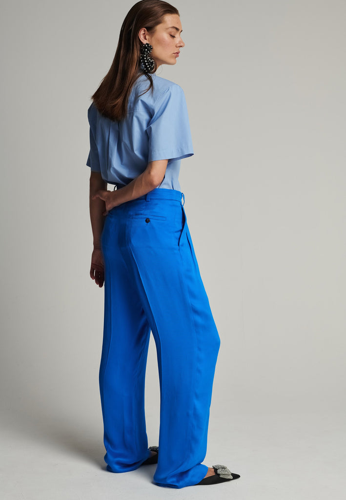 Wide-leg striped satin pants in blue. Features pockes, belt loops, and pressed front pleats. True to size.