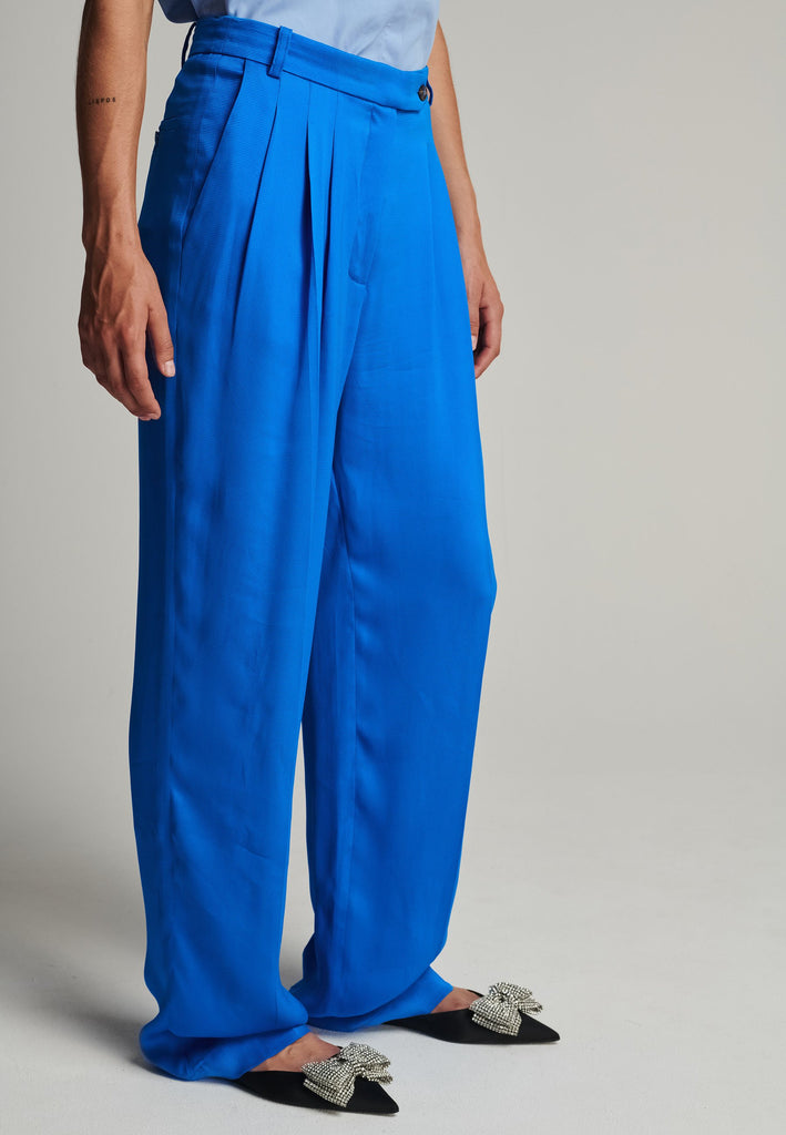 Wide-leg striped satin pants in blue. Features pockes, belt loops, and pressed front pleats. True to size.