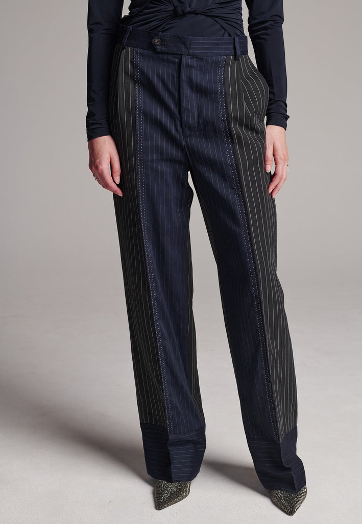 Long wide-leg trousers cut from two faintly pinstriped linen blends. Detailed with welt pockets and button closure.