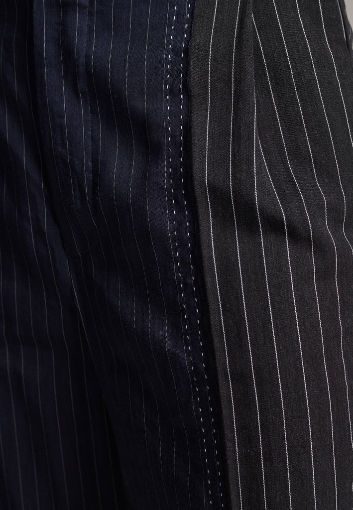 Long wide-leg trousers cut from two faintly pinstriped linen blends. Detailed with welt pockets and button closure.