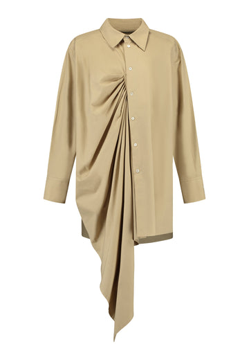 Oversized asymmetric shirt. Specially detailed with a long ruffle effect on one side. It has a button closure to adjust the neckline. 100% Cotton and with an oversized loose shape. Designed for a comfortable and unique fit. A timeless piece.