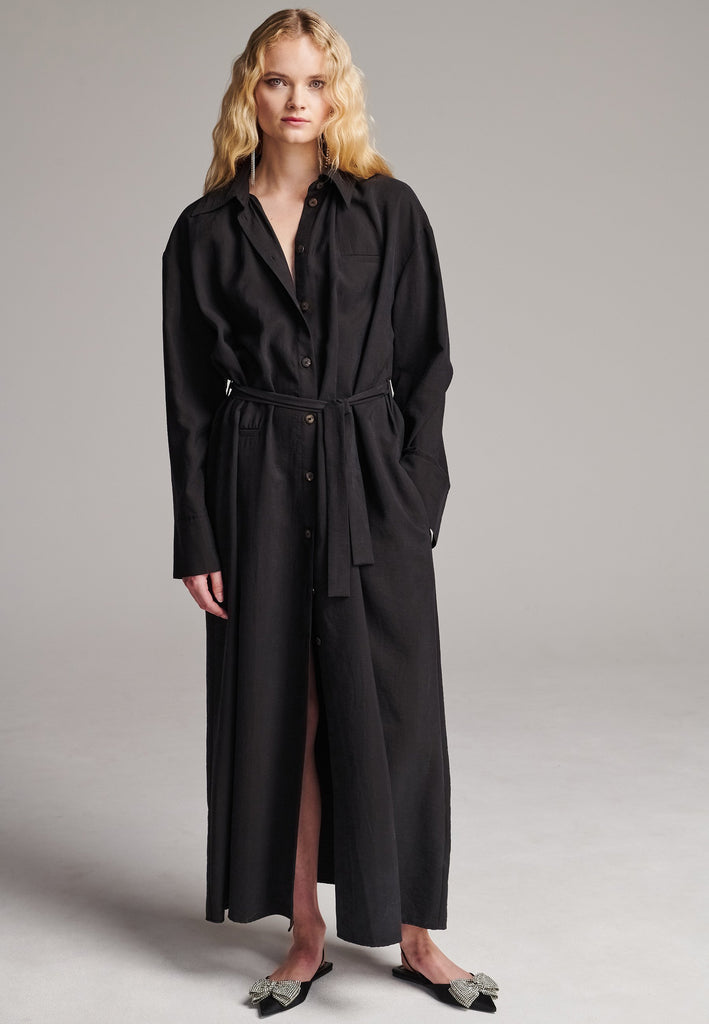 Shirt dresses are closet mainstays that effortlessly evolve from workwear to evening wear. This very cool straight cut, dropped shoulder maxi dress was designed for an oversized fit. Cut from fine crinkle washed look viscose, deepen the front split by unbutton it. Features a belt to cinch in your shape.