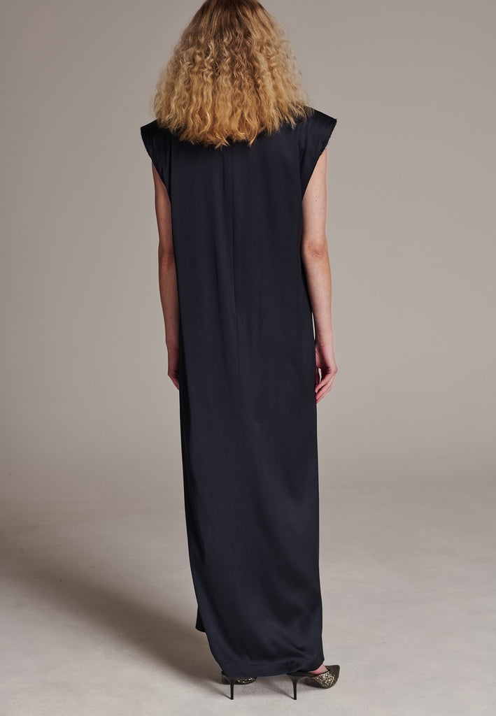 FRENKEN'S comfortable stretch-satin maxi dress is draped in a way that feels equally effortless and elegant. Raw-cut edge at the dramatically wide shoulders for a strong silhouette. Particularly long in length. Thoughtfully designed with gathered detailing, it offers a flattering fit that subtly conceals the midsection. Continue the leg-lengthening illusion of the glamorous front high-slit with point-toe pumps. Designed for a draped silhouette, cut to be worn very loose and very oversized. This dress ensure