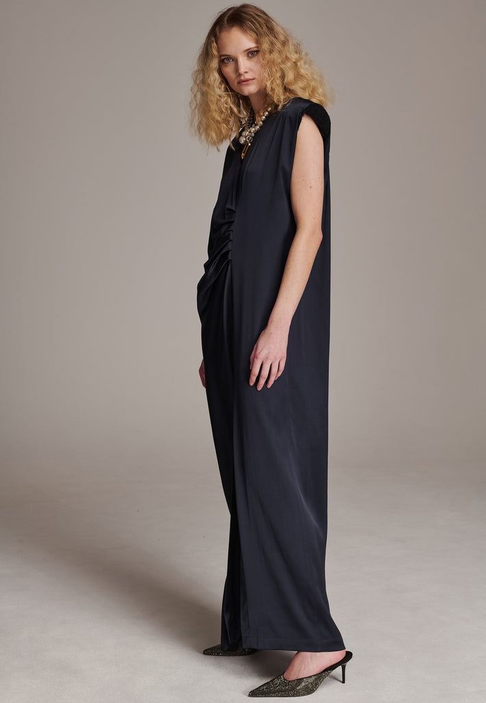 FRENKEN'S comfortable stretch-satin maxi dress is draped in a way that feels equally effortless and elegant. Raw-cut edge at the dramatically wide shoulders for a strong silhouette. Particularly long in length. Thoughtfully designed with gathered detailing, it offers a flattering fit that subtly conceals the midsection. Continue the leg-lengthening illusion of the glamorous front high-slit with point-toe pumps. Designed for a draped silhouette, cut to be worn very loose and very oversized. This dress ensure