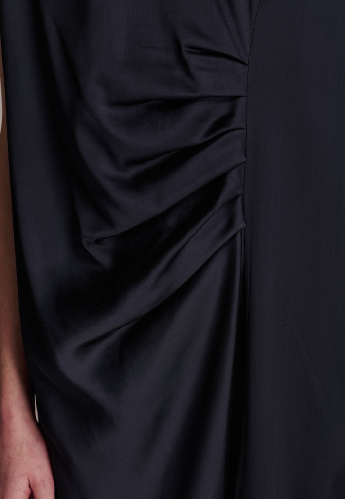 FRENKEN'S comfortable stretch-satin maxi dress is draped in a way that feels equally effortless and elegant. Raw-cut edge at the dramatically wide shoulders for a strong silhouette. Particularly long in length. Thoughtfully designed with gathered detailing, it offers a flattering fit that subtly conceals the midsection. Continue the leg-lengthening illusion of the glamorous front high-slit with point-toe pumps. Designed for a draped silhouette, cut to be worn very loose and very oversized. This dress ensure