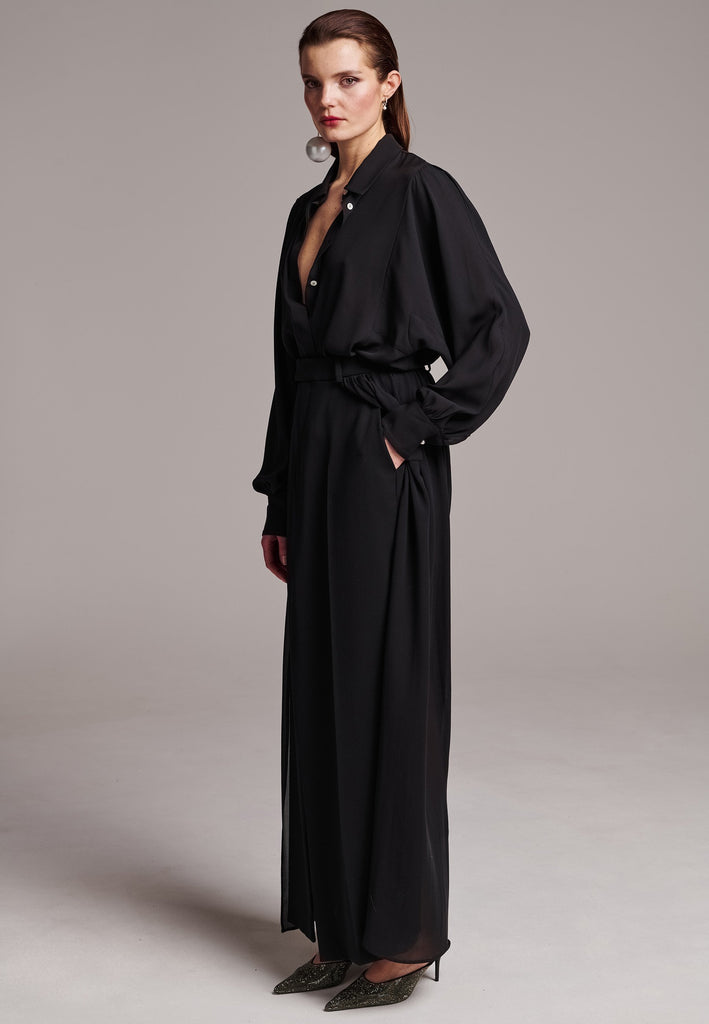 Voluminous poplin shirt with puffed subtle gathered shoulders. Specially detailed with a square armhole seam to create a voluminous sleeve. It has six-hole buttons to adjust the neckline. Cut from 100% silk. Designed for a relaxed fit, cut to be worn very loose. Embellished with a faux pearl on the cuff. This style will go hand in hand with jeans and tailoring.