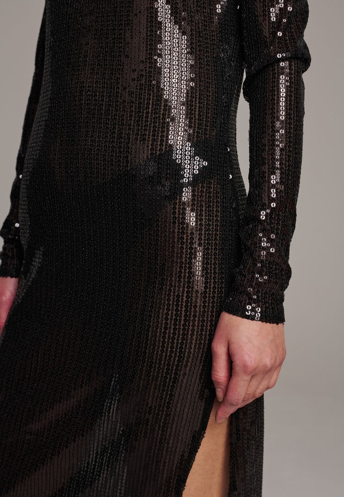 Body-hugging maxi dress, designed for a unique fit. Featuring a see-through shimmer effect, shoulder-pads and turtleneck.