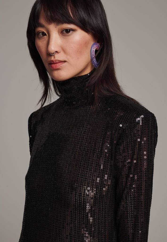 Body-hugging maxi dress, designed for a unique fit. Featuring a see-through shimmer effect, shoulder-pads and turtleneck.