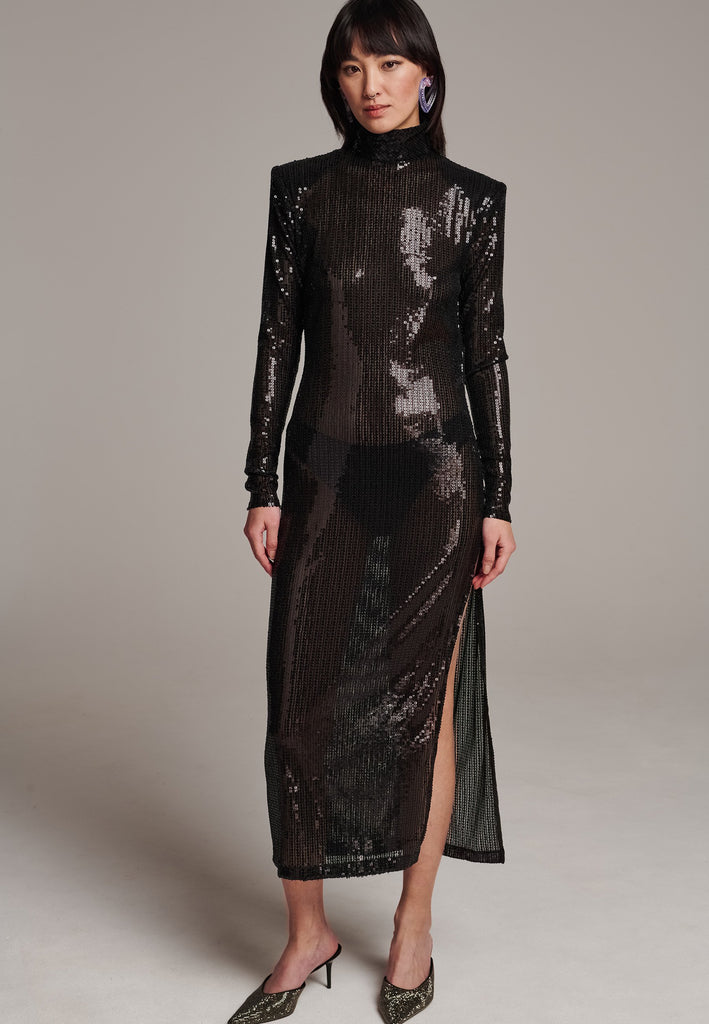 Body-hugging maxi dress, designed for a unique fit. Featuring a see-through shimmer effect, shoulder-pads and turtleneck.