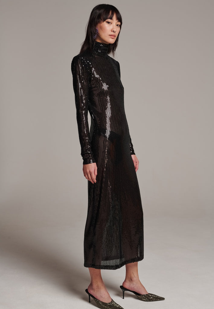 Body-hugging maxi dress, designed for a unique fit. Featuring a see-through shimmer effect, shoulder-pads and turtleneck.