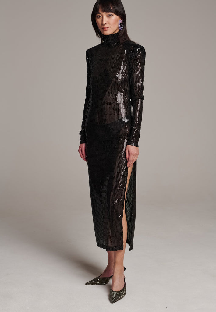 Body-hugging maxi dress, designed for a unique fit. Featuring a see-through shimmer effect, shoulder-pads and turtleneck.