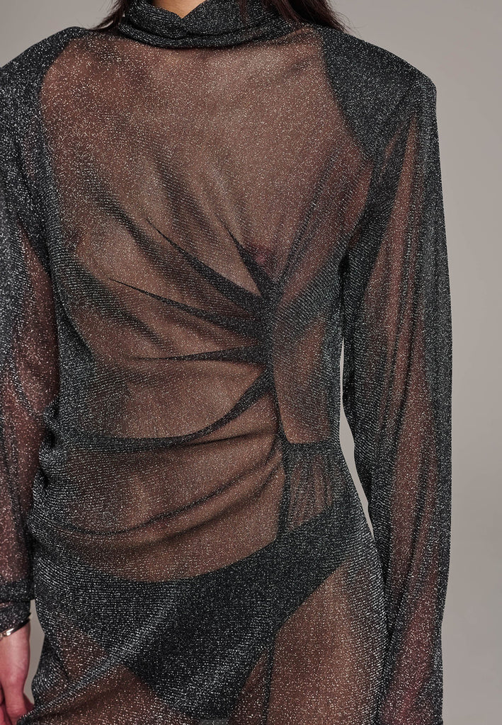 Body-hugging maxi dress, designed for a unique fit. Featuring a see-through shimmer effect and turtleneck.
