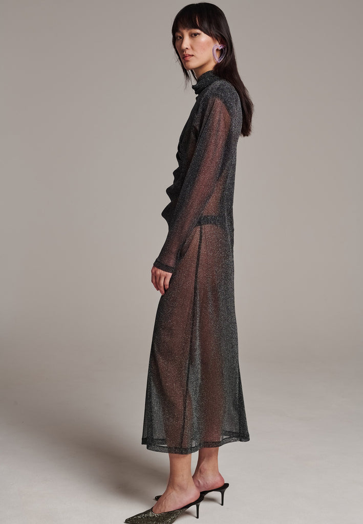 Body-hugging maxi dress, designed for a unique fit. Featuring a see-through shimmer effect and turtleneck.