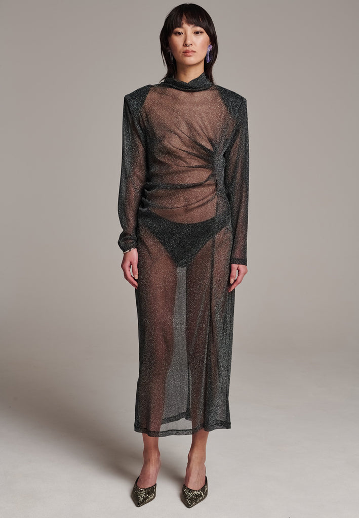 Body-hugging maxi dress, designed for a unique fit. Featuring a see-through shimmer effect and turtleneck.