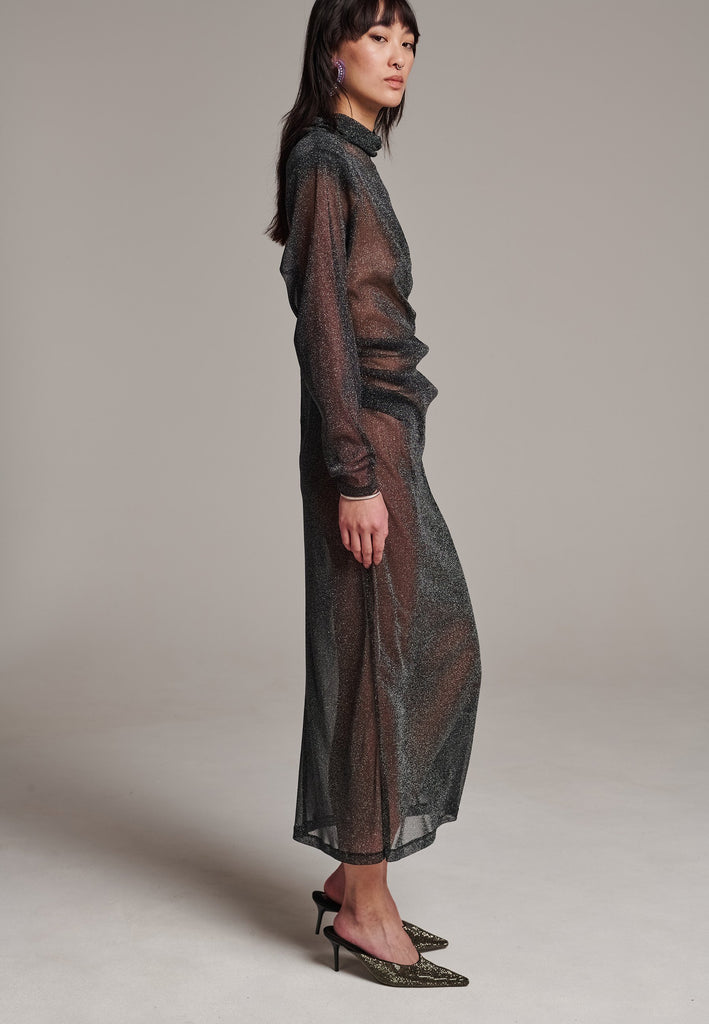 Body-hugging maxi dress, designed for a unique fit. Featuring a see-through shimmer effect and turtleneck.