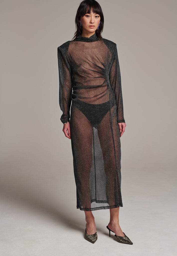 Body-hugging maxi dress, designed for a unique fit. Featuring a see-through shimmer effect and turtleneck.