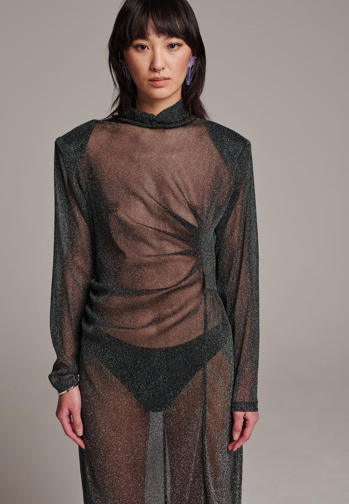 Body-hugging maxi dress, designed for a unique fit. Featuring a see-through shimmer effect and turtleneck.