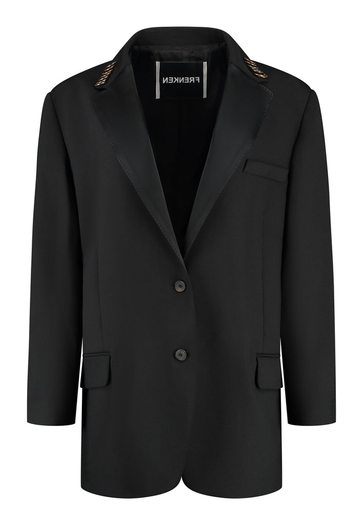 A classic yet oversized blazer, designed to make a bold statement while maintaining timeless appeal. The lower portion of the lapels is crafted from a contrasting shiny fabric, adding an unexpected touch of texture and luxury. The upper part of the collar area is beautifully embellished with gold and silver rings at the tips, offering a refined, modern twist. This piece combines traditional tailoring with avant-garde details, perfect for elevating any outfit with sophistication and edge.