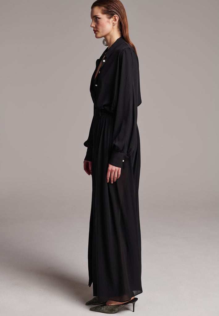 A see-through skirt featuring a front slit and belt loops.