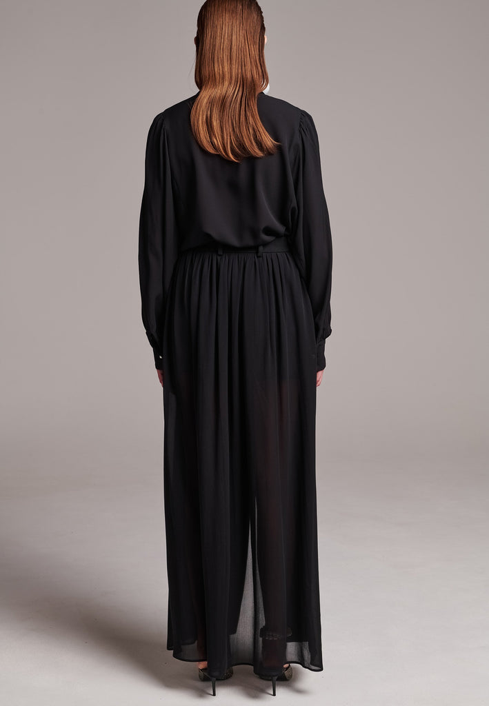 A see-through skirt featuring a front slit and belt loops.