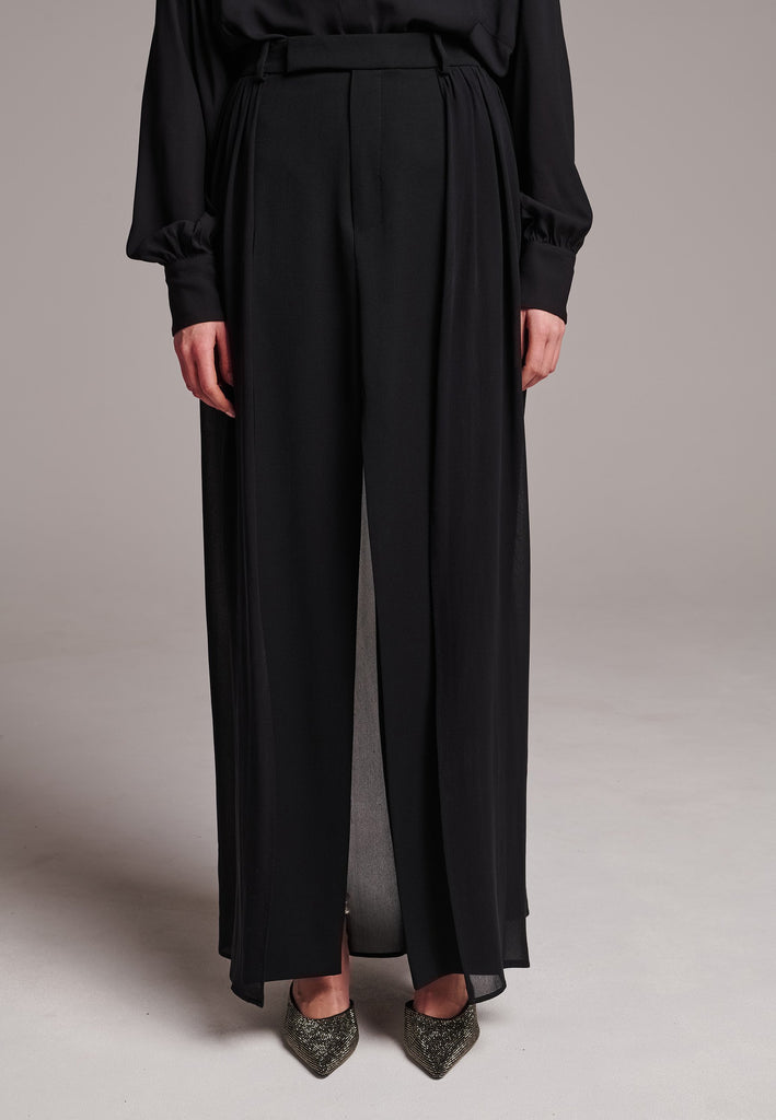 A see-through skirt featuring a front slit and belt loops.