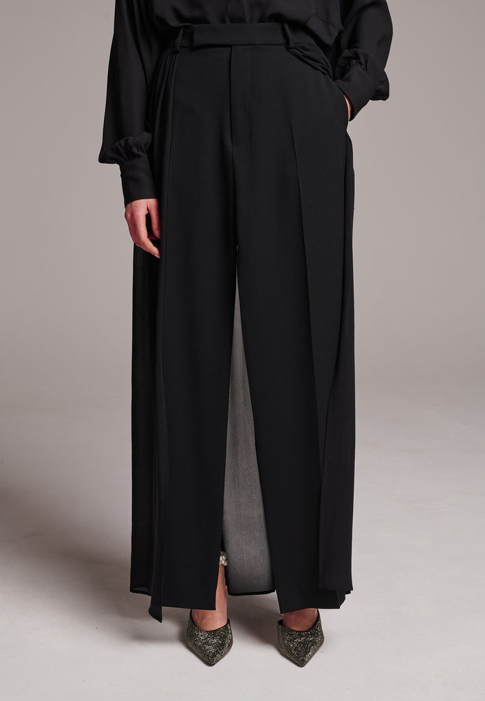 A see-through skirt featuring a front slit and belt loops.