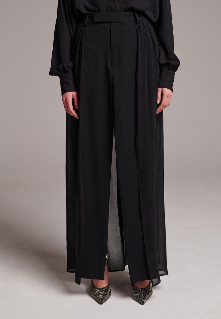 A see-through skirt featuring a front slit and belt loops.