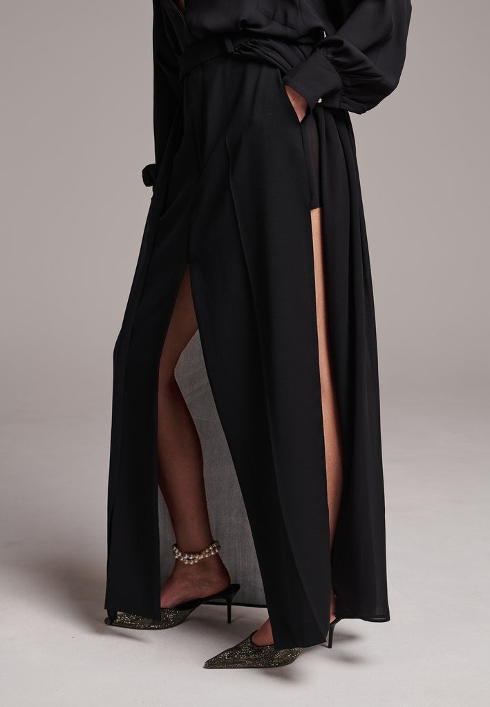 A see-through skirt featuring a front slit and belt loops.