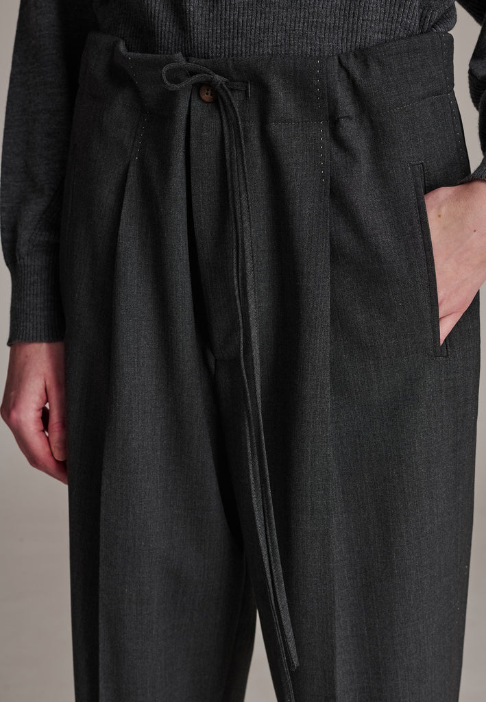 Refine your wardrobe with these straight-leg trousers, cut from a soft virgin wool. Featuring a sophisticated horn button and zip with a drawstring fastening at the waist. With a nod to the tuxedo pants, it has a fabric self-stripe with a needle point at the side seam. Complete with slanted pockets and welt back pockets, these trousers blend traditional elegance with modern functionality.