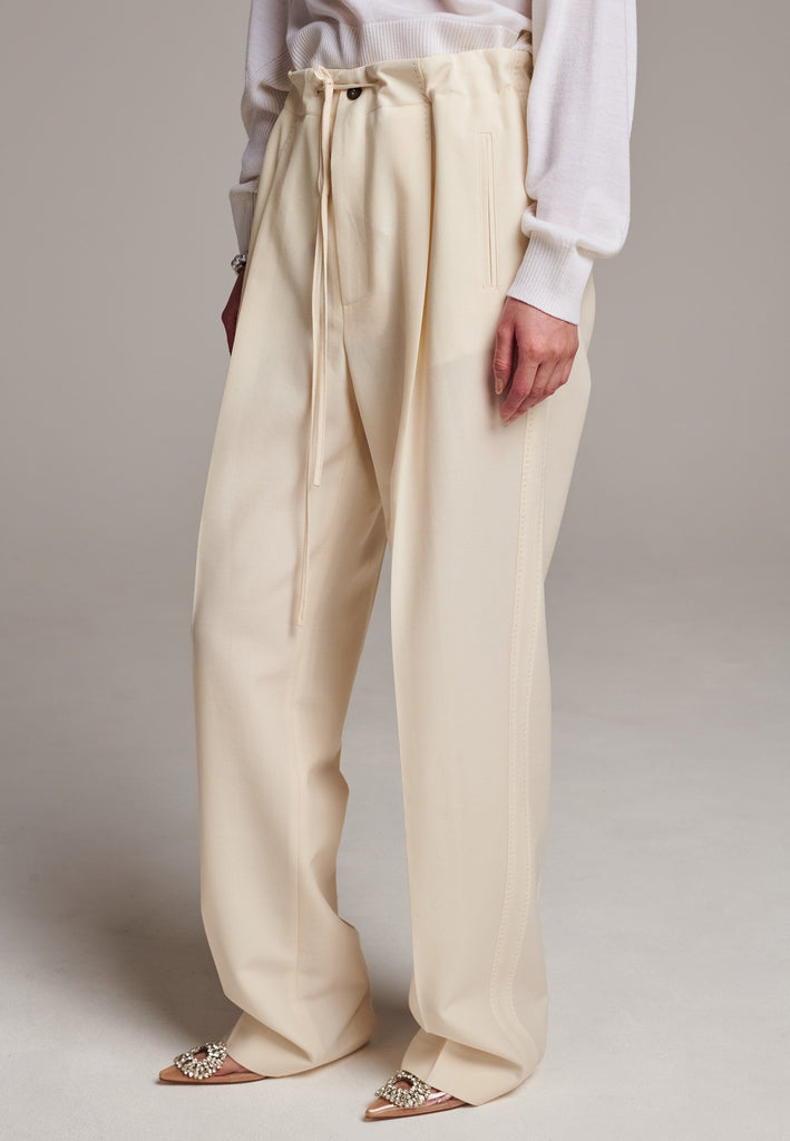 Refine your wardrobe with these straight-leg trousers, cut from a soft virgin wool. Featuring a sophisticated horn button and zip with a drawstring fastening at the waist. With a nod to the tuxedo pants, it has a fabric self-stripe with a needle point at the side seam. Complete with slanted pockets and welt back pockets, these trousers blend traditional elegance with modern functionality.