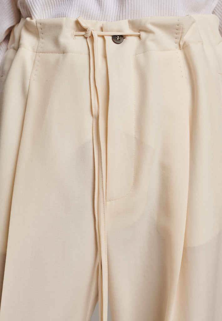 Refine your wardrobe with these straight-leg trousers, cut from a soft virgin wool. Featuring a sophisticated horn button and zip with a drawstring fastening at the waist. With a nod to the tuxedo pants, it has a fabric self-stripe with a needle point at the side seam. Complete with slanted pockets and welt back pockets, these trousers blend traditional elegance with modern functionality.