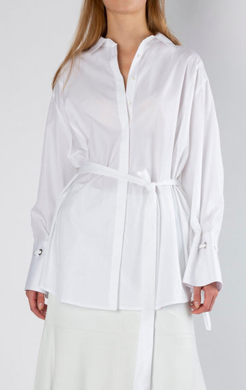 Hole | Shirt | White. Loose fit belted shirt with oversized cuff. Made from crispy poplin cotton detailed with eyelets and straps to create gathered cuffs. frenkenfashion.com