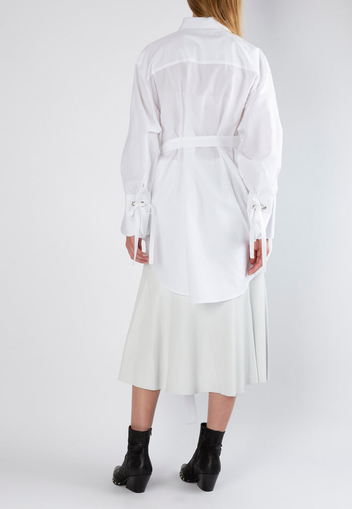 Hole | Shirt | White. Loose fit belted shirt with oversized cuff. Made from crispy poplin cotton detailed with eyelets and straps to create gathered cuffs. frenkenfashion.com