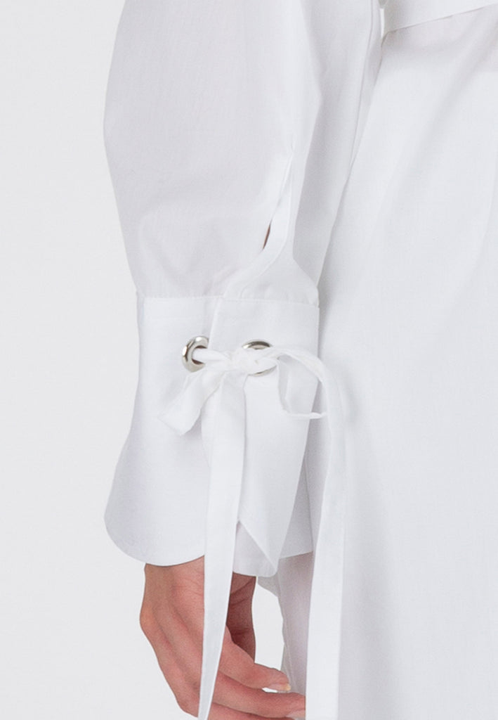 Hole | Shirt | White. Loose fit belted shirt with oversized cuff. Made from crispy poplin cotton detailed with eyelets and straps to create gathered cuffs. frenkenfashion.com