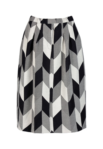 Mozaik skirt, black and off-white color. Graphic checked midi skirt with elastic waistband. Cut from a wool blend with pockets. Style yours with a gingham poplin or a toned body hugging turtleneck.