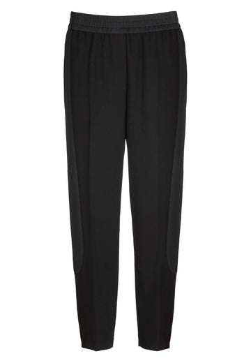 Black pants with elasticated waist and side satin contrast on leg. With this, you will get either a formal look with a blazer and pump or create a casual look with a T-Shirt and a sneaker. FRENKEN fashion brand. Composition: 88% Polyester 12% Elastane