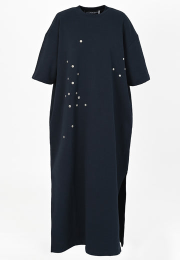 Peak | Dress | Navy. Maxi dress fabricated in soft navy interlock. The dropped sleeves emphasize the oversized look, with metallic eyelets and press buttons, inspired by the functionality, for an unexpected leisurewear statement piece. With side slits for extra comfort, to wear inside and out.