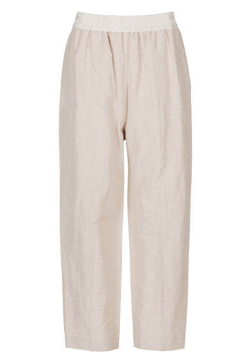 FRENKEN Cave beige trouser with a white elastic waistband and side pockets. Accented with softly pressed creases for the perfect fitting. Also available in black.