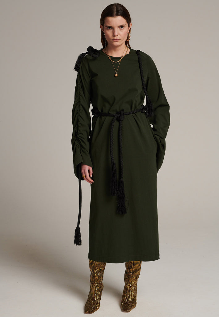 FRENKEN oversized jersey dress with long wide sleeves crafted in soft light dark green cotton, detailed with this season's cord theme. The chunky cords are displayed along the sleeves and can be pulled out to create shape and to shorten the sleeves, making the most of this statement style. The cord ends are hand frayed, a refined couture detail.